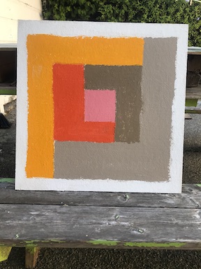 A work--in-progress photograph of an acrylic painting placed outside on an old picnic bench